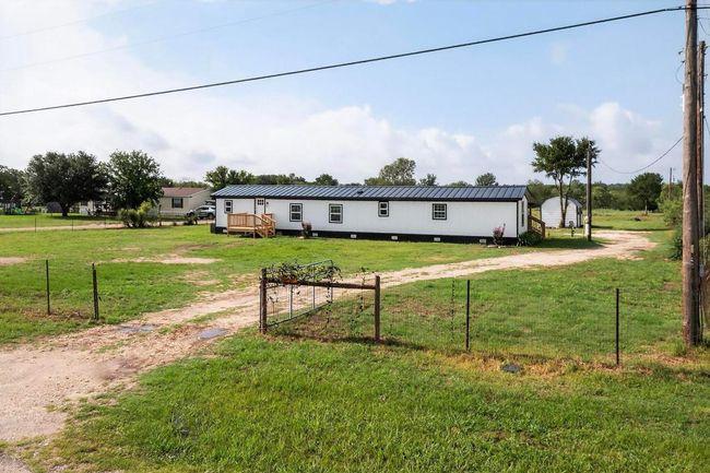 Manufactured / mobile home featuring metal roof, driveway, and a front yard | Image 8