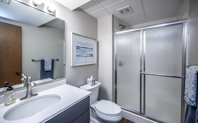 Updated 3/4 bath with LVP flooring, higher vanity upgraded with dovetail drawer construction & soft close, shower seating, convenient linen closet in hallway. | Image 34