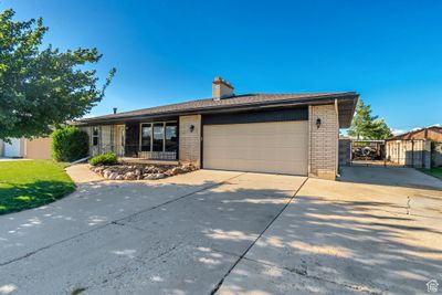 View of front of home featuring a garage and a porch | Image 1