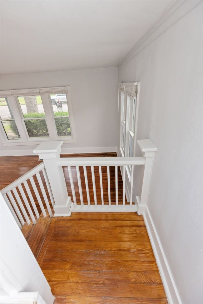 Stairway with baseboards and wood finished floors | Image 7
