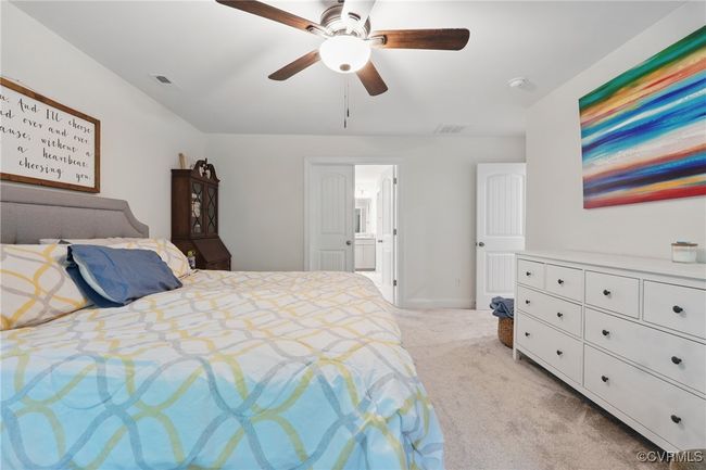 Bright and spacious primary retreat with ceiling fan and neutral finishes. | Image 18