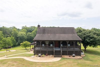 View of front of property with a deck and a front yard | Image 1