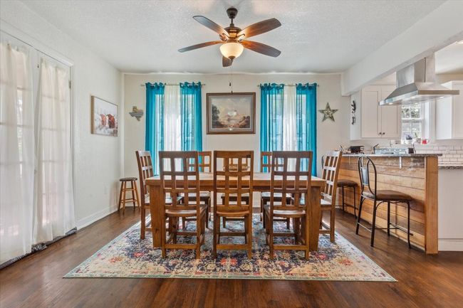 Dining space with baseboards, a textured ceiling, a ceiling fan, and dark wood finished floors | Image 9