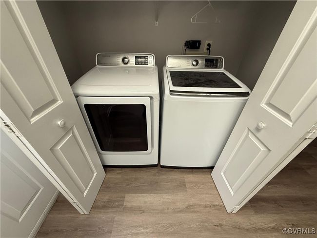 Laundry area featuring washer and clothes dryer and wood finished floors | Image 9