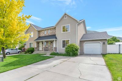 View of front property featuring a front lawn and a garage | Image 3