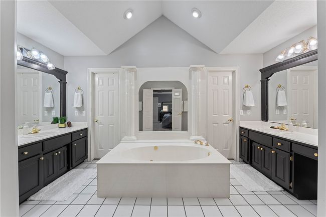 Doors on both sides of tub lead to a large walk-in closet | Image 17
