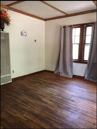 Empty room with dark wood-type flooring | Image 3