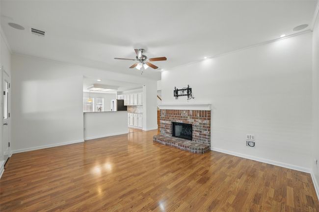 The living room is viewed from the kitchen & eat-in which is off of the garage. | Image 10