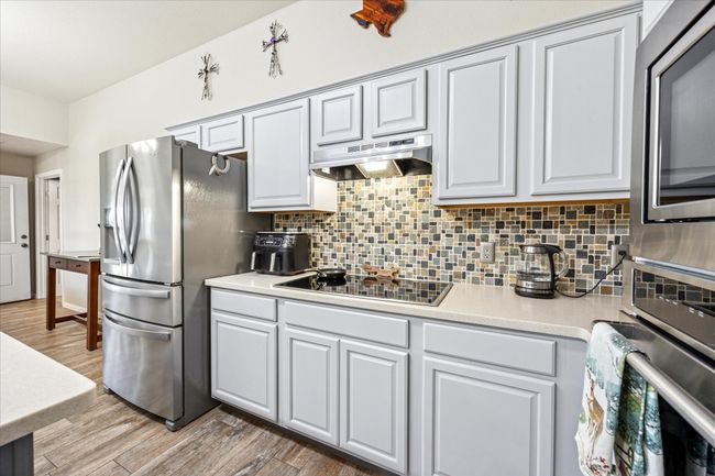 Beautifully refreshed kitchen with updated cabinetry and sleek stainless steel appliances for a modern touch. | Image 9