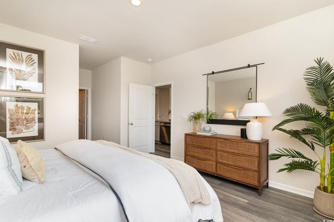 Bedroom featuring baseboards, wood finished floors, and visible vents | Image 14