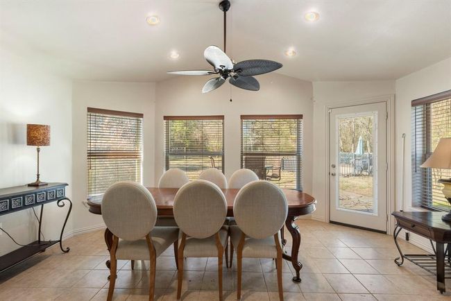 Enclosed porch could function as a sun room or formal dining space. | Image 26
