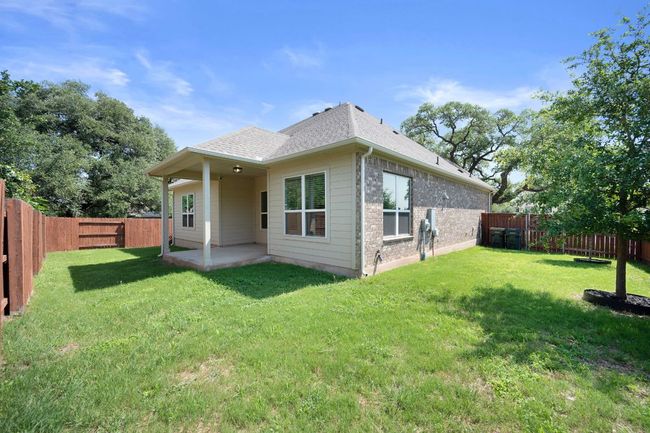 Back of house with a patio, a shingled roof, and brick siding | Image 33