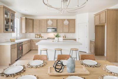 Kitchen with light hardwood / wood-style floors, tasteful backsplash, a kitchen island, and stainless steel appliances | Image 3