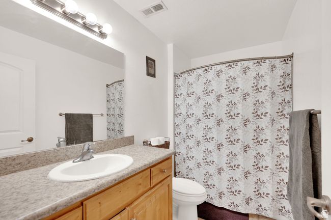 Full bathroom with vanity and curtained shower | Image 10