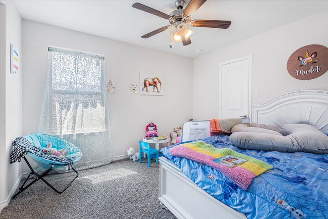 Bedroom with carpet, baseboards, and a ceiling fan | Image 25