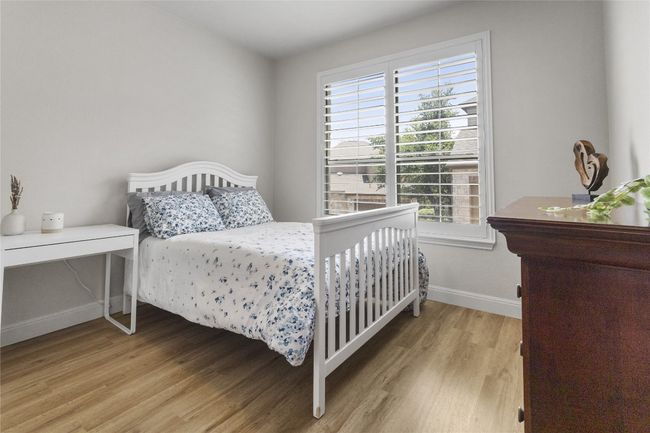 light, bright secondary bedroom with beautiful flooring continuing. | Image 16