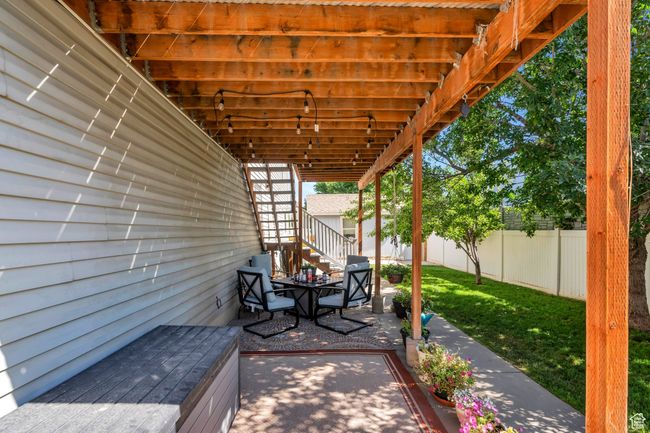 Fenced backyard with a patio area | Image 24