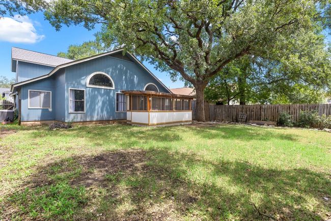 Beyond the porch, the yard stretches wide beneath a canopy of mature oak trees. It’s shaded, private, and full of potential. | Image 34