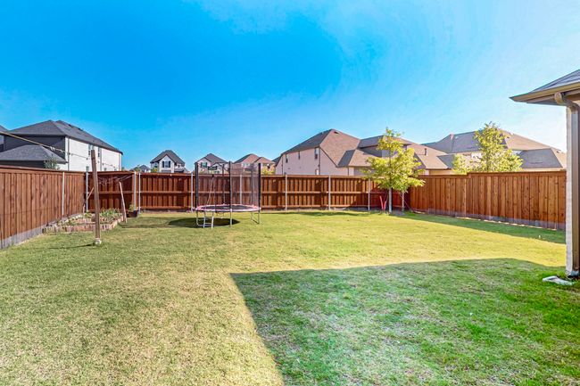 View of yard featuring a residential view and a trampoline | Image 40
