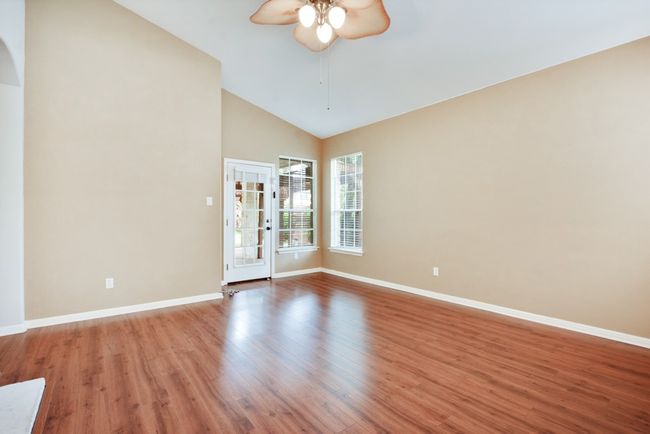 The main living area centers around a cozy fireplace, with effortless flow into the kitchen and dining space—perfect for gathering with friends and family. | Image 19