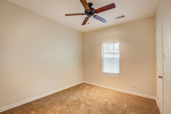 Carpeted spare room featuring baseboards and ceiling fan | Image 26