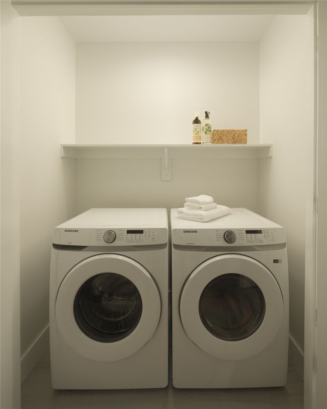 Laundry area with washer and clothes dryer and baseboards | Image 26