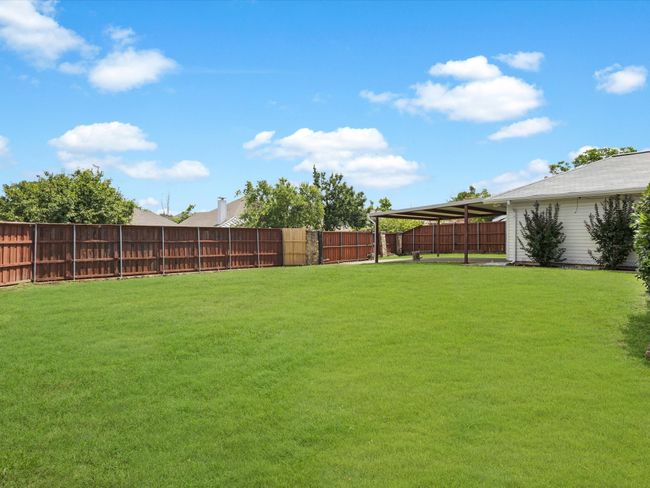 View of fenced backyard | Image 24