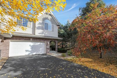 Brick detail and a covered porch make this end unit a fabulous place to call home. | Image 2