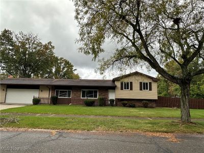 View of front of home with a front lawn and a garage | Image 1