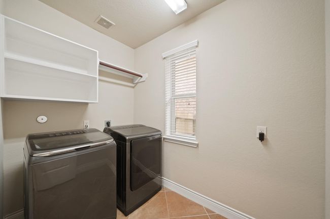 This is a bright laundry room featuring built-in shelving, and a window for natural light. (Washer & Dryer do not convey). | Image 25