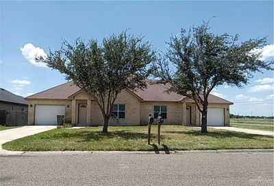 Ranch-style house featuring a front yard and a garage | Image 1