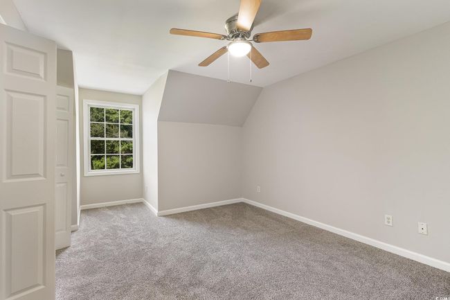 Additional living space with lofted ceiling, carpet, a ceiling fan, and baseboards | Image 19
