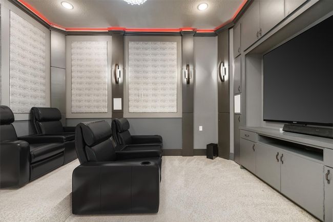 Tucked behind the custom, hidden shelves, you'll find this fully custom home theater. | Image 5