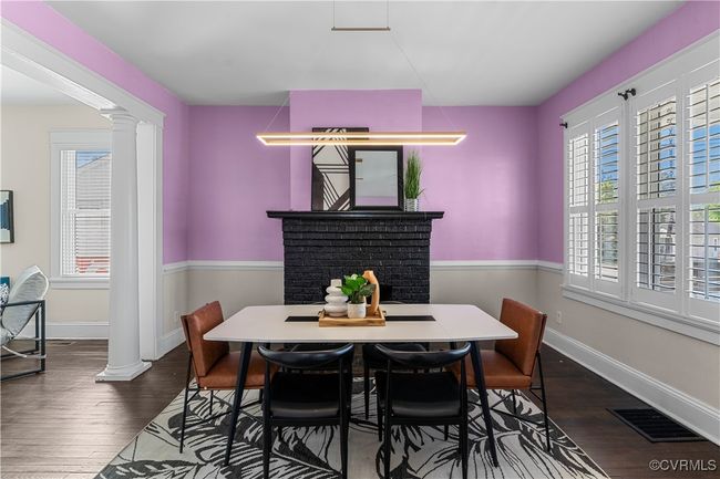 Dining area featuring baseboards, dark wood-style flooring, visible vents, and decorative columns | Image 7