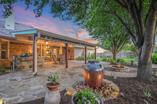 Patio terrace at dusk with a fire pit, area for grilling, and a patio area | Image 33