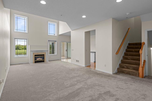 The fireplace is the center of the grand, two story living room. | Image 5