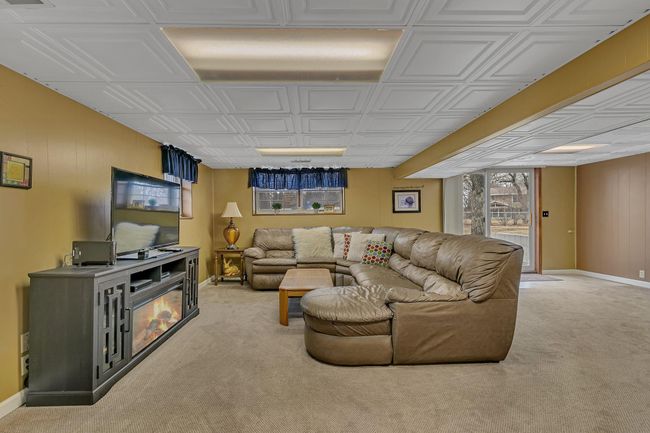 Lower level Living Room with walk out to concrete patio and large side yard | Image 19
