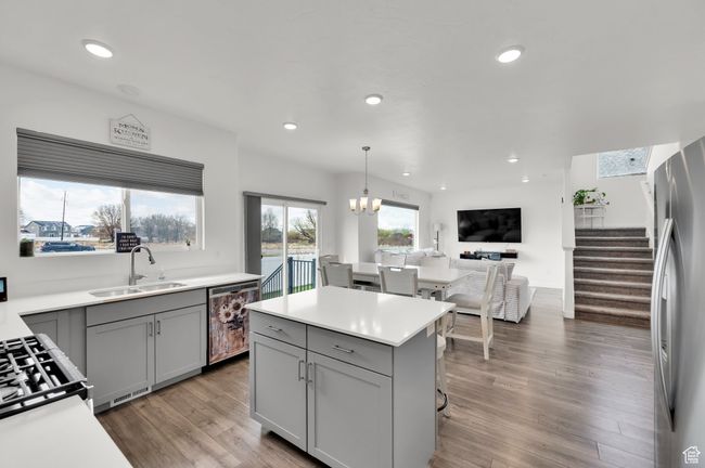 Kitchen with freestanding refrigerator, dishwashing machine, a sink, and gray cabinetry | Image 5