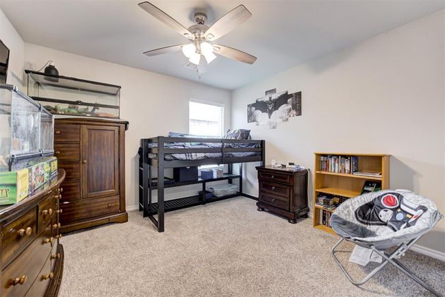 Bedroom with light carpet and a ceiling fan | Image 29