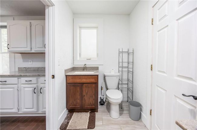 Bathroom featuring baseboards, toilet, and vanity | Image 46