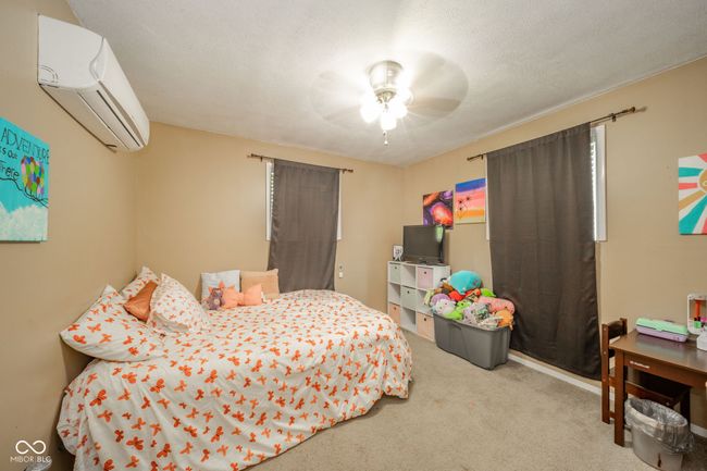 bedroom featuring a wall unit AC, carpet, and a ceiling fan | Image 29
