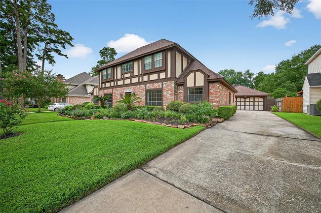 A long, elegant driveway stretches to the rear, guiding you toward a detached two-car garage with its own A/C—perfect for transforming into a studio, gym, or workshop with ease. | Image 5