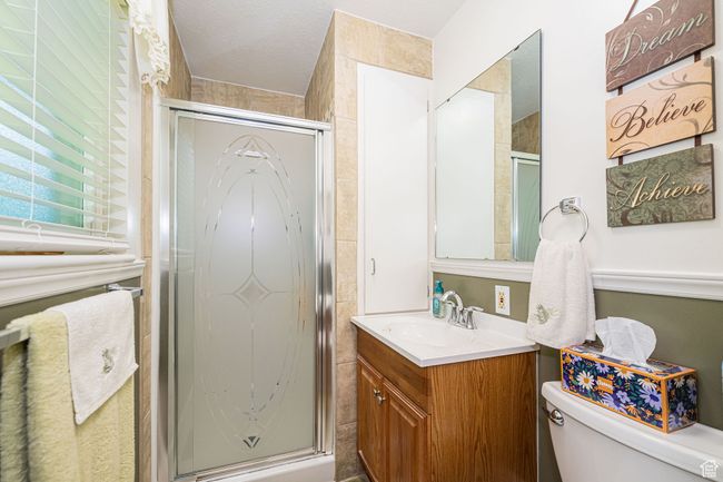 Full bath with vanity, a stall shower, and toilet | Image 34