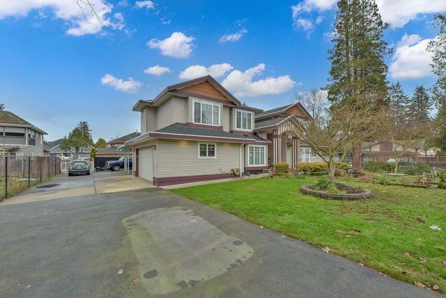 View of front of property featuring asphalt driveway and a garage | Image 6