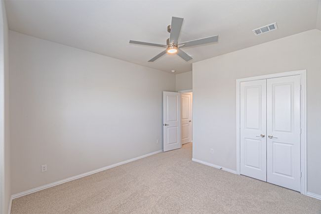 Unfurnished bedroom with light colored carpet, a closet, and ceiling fan | Image 36