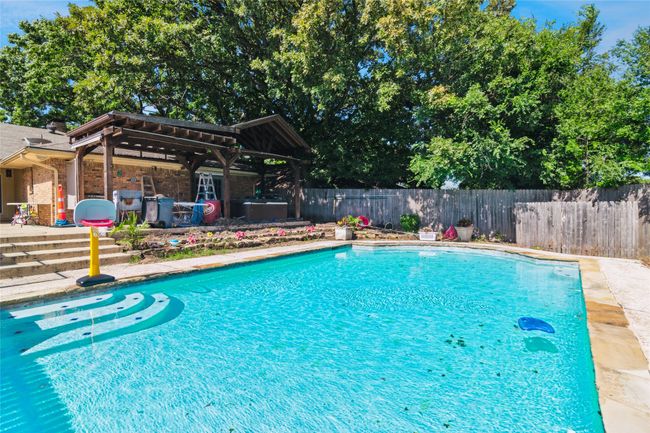 View of swimming pool with a fenced backyard, a patio, and a gazebo | Image 24