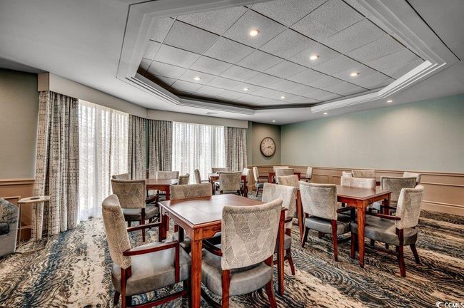 Dining space featuring a tray ceiling | Image 34