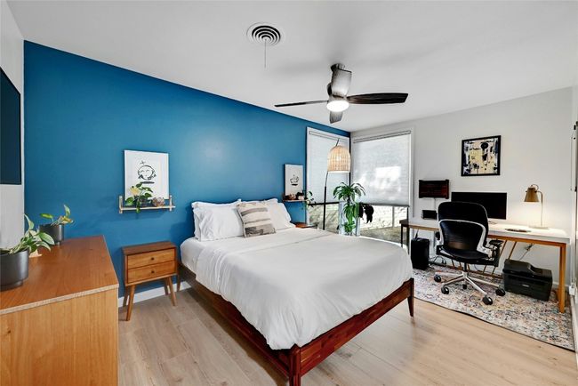 This bedroom features a ceiling fan, floor-to-ceiling windows, and Vinyl Plank flooring throughout. | Image 21