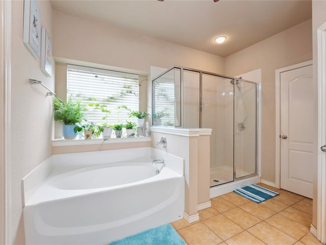 Full bath featuring a bath, a stall shower, and tile patterned floors | Image 19
