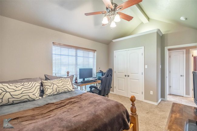 Bedroom with light colored carpet, a closet, ceiling fan, and baseboards | Image 19